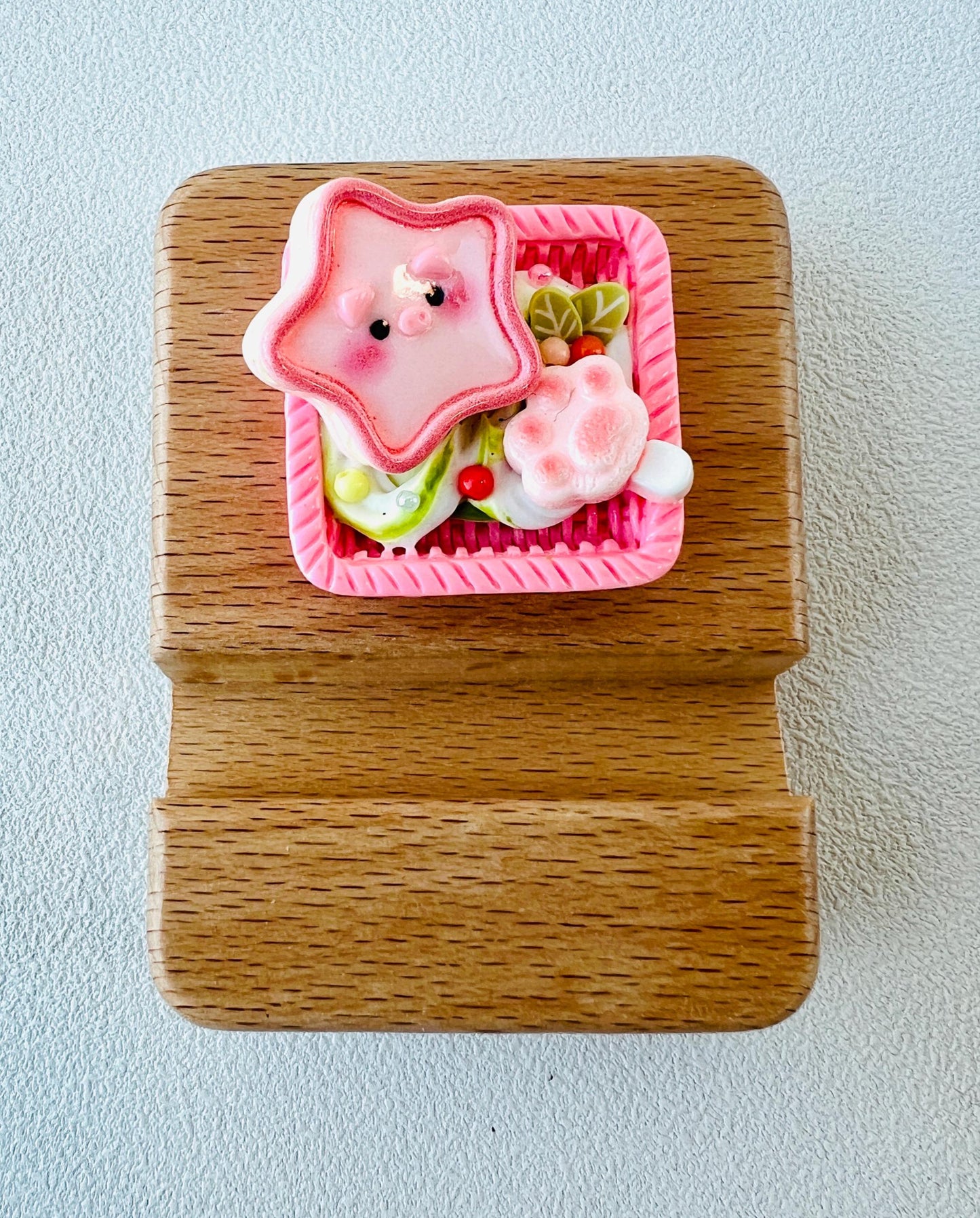 Personalized wooden phone stand with cute pig design