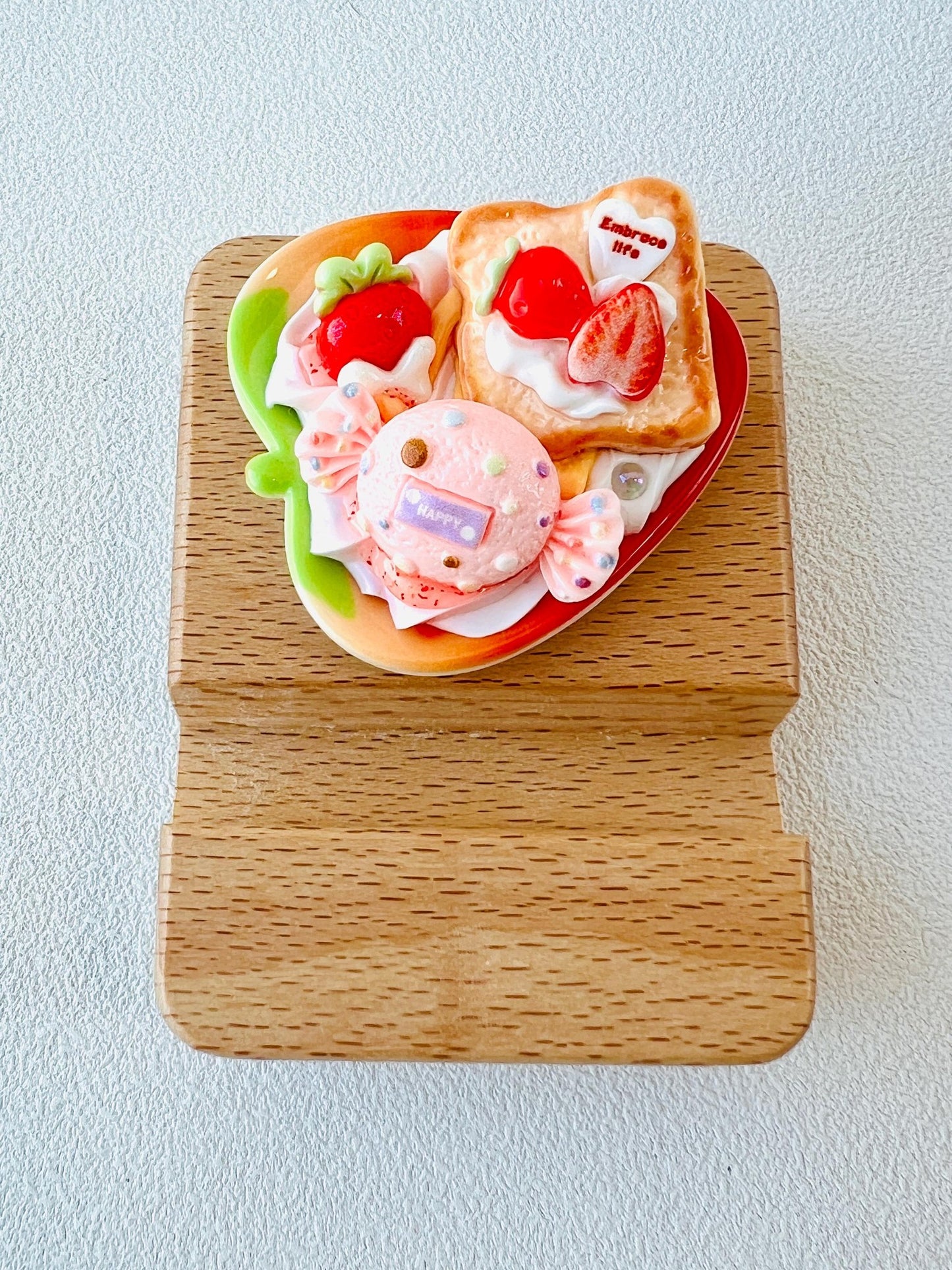 Personalized wooden phone stand with cute strawberry dessert design