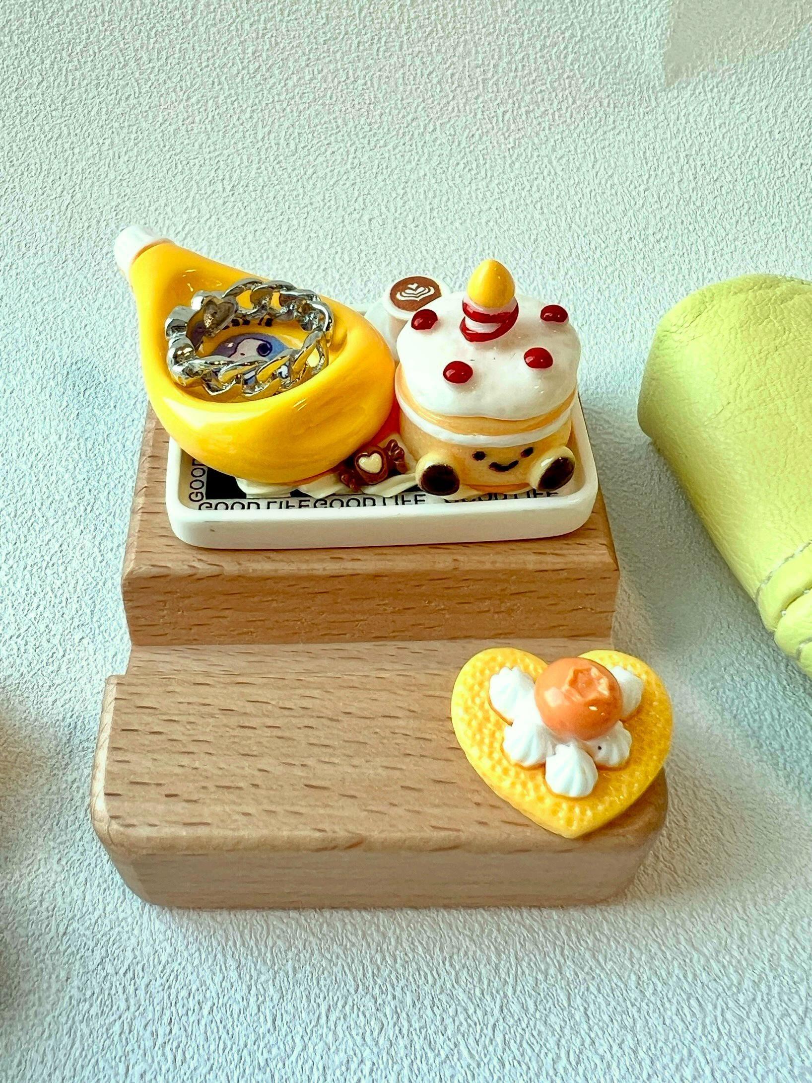 wooden phone stand decorated with cute food charms